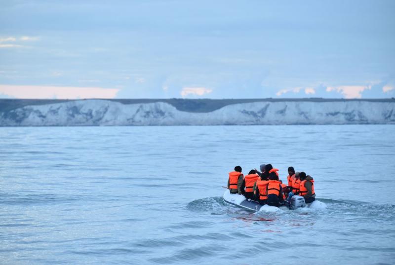 refugees cross the channel in a boat