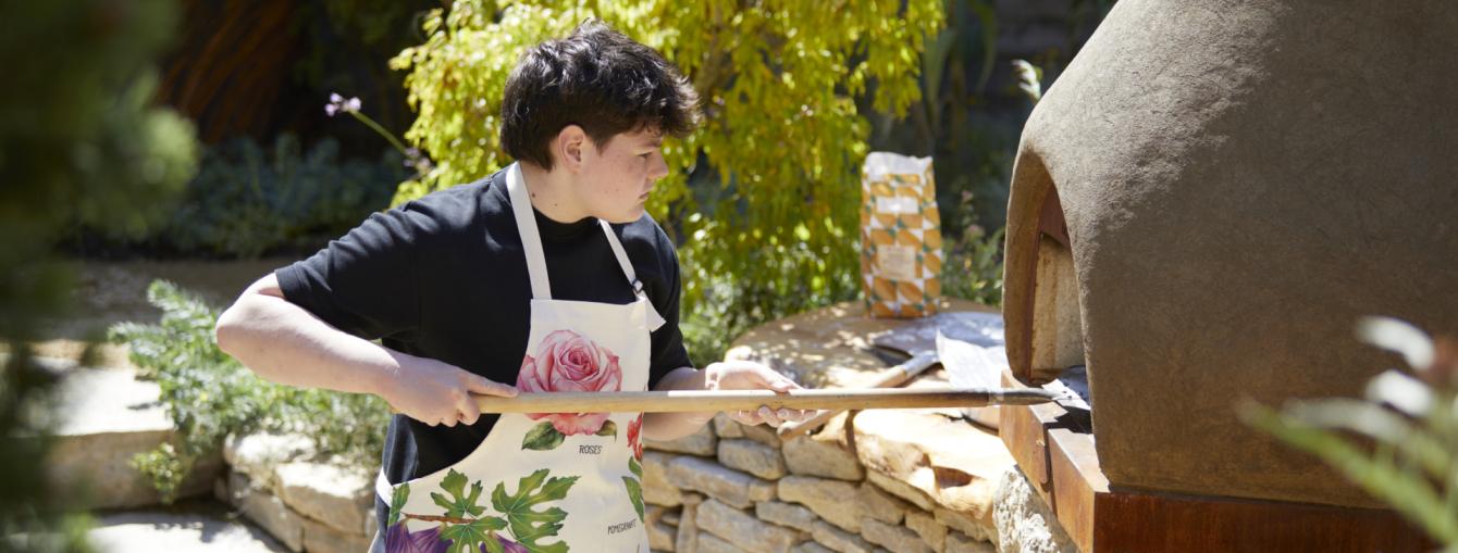 Young person using a bread oven