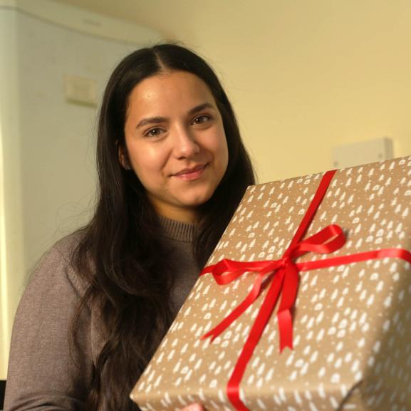 Young girl holding Christmas present