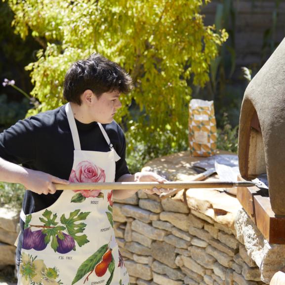 Young person using a bread oven