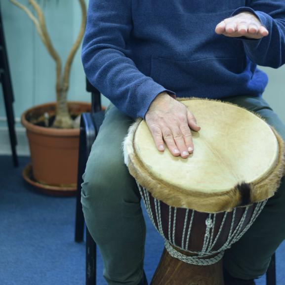 An undidentifiable person playing African drums