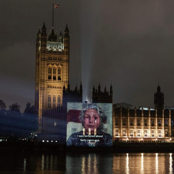 Video of survivor projected onto Houses of Parliament