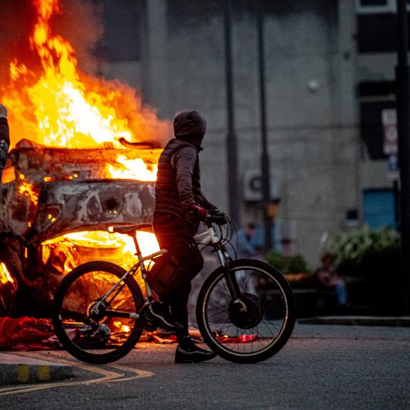 A police car is set on fire as Far-right activists riot