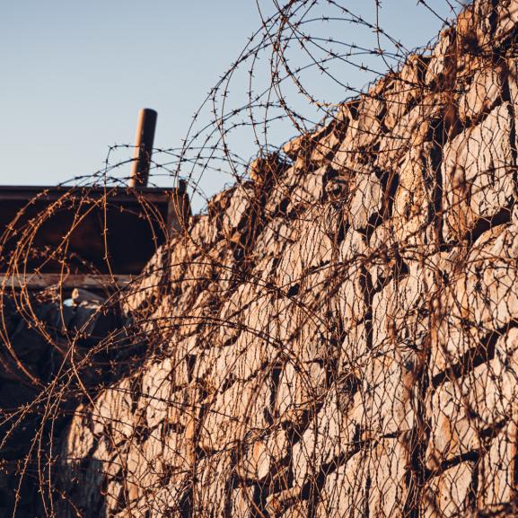 Barbed wire and wall