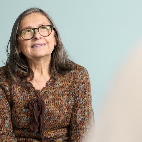 Older woman smiling to side of camera