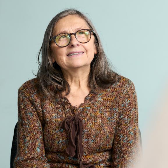 Older woman smiling to side of camera