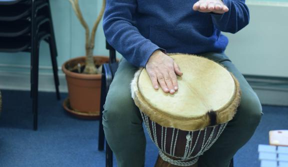 An undidentifiable person playing African drums