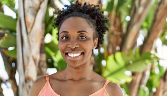 Middle aged Black woman smiling at camera