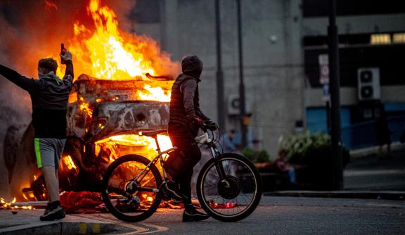 A police car is set on fire as Far-right activists riot