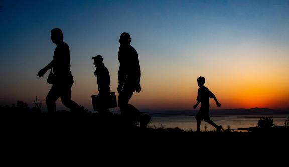 Silhoutte of a group of people walking