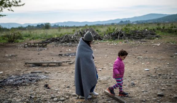 Woman and child walking along dry land