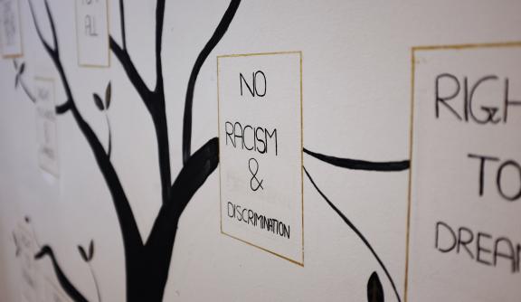 An illustration of a tree, with a caption reading "No racism & discrimination"