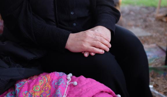 An older woman's hands cusped together